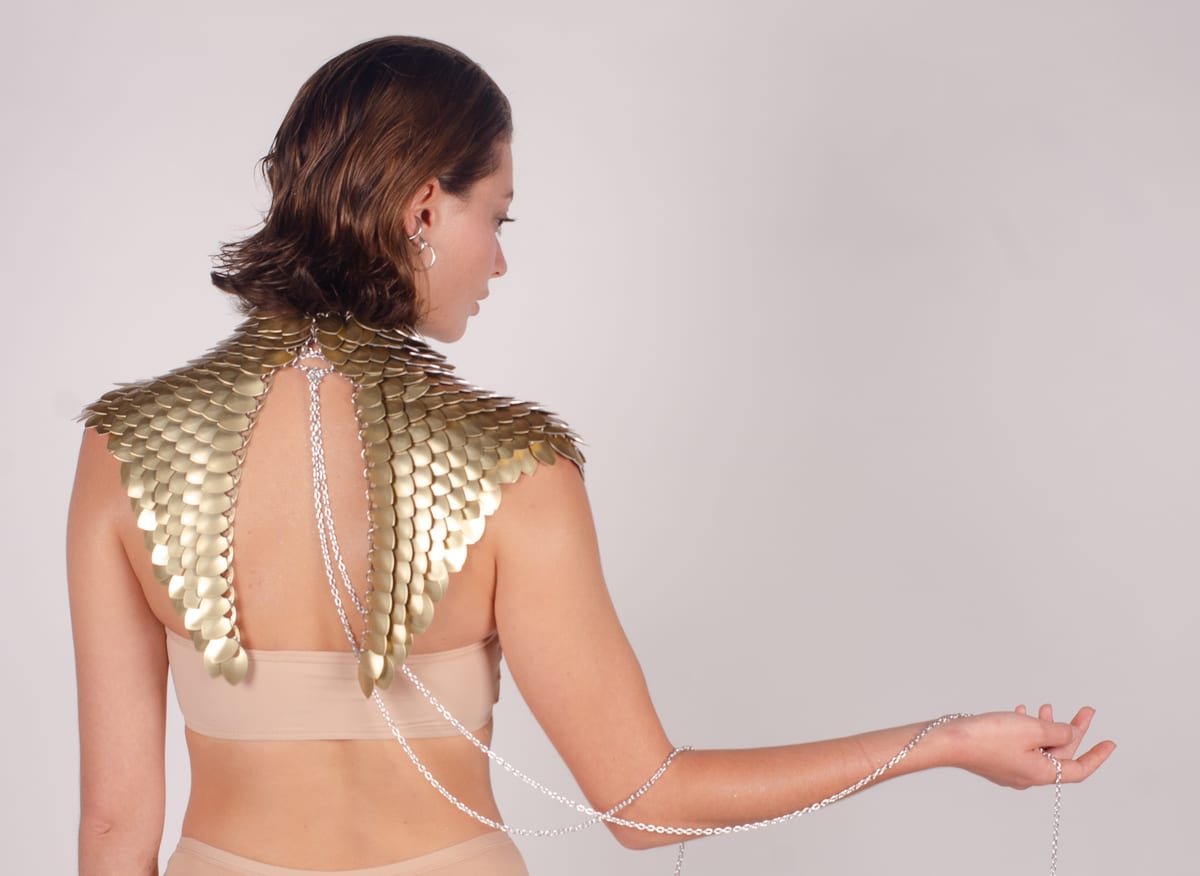 Back view of a gold-scale DOST piece with draped chains